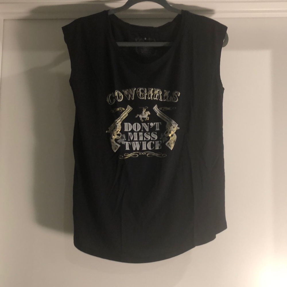 Sleeveless shirt saying cowgirls don’t miss twice